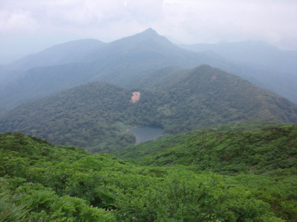 三本槍ヶ岳から大峠に下る途中で、鏡が沼（手前）と赤崩山（奥の三角錐の山）が見られる。